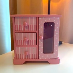 Light pink wooden jewelry box.